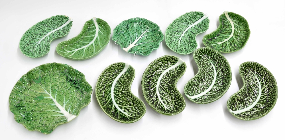 Assorted Portuguese majolica green glaze leaf dishes, four F. Subtil crescent examples, 8" long,