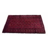 Turkaman red ground rug, repeated geometric design within multiple geometric borders, 67" x 45"