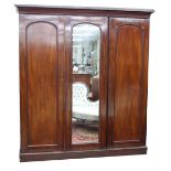 Victorian mahogany triple front robe, the moulded cornice over three panelled doors, the central