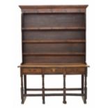 George III small oak dresser, with Delft rack over the base fitted with three short drawers