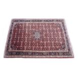 Oriental type red ground rug, the central flower head medallion within an allover geometric motif