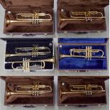 *Seven various gold lacquered student quality trumpets, mostly in need of some restoration (six