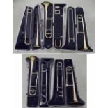 *Five various cased gold lacquered trombones; two Jupiter, two Blessing and a Boosey & Hawkes York