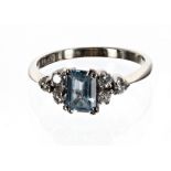 18ct white gold blue topaz and diamond ring, the emerald-cut aquamarine 0.85ct approx, with three