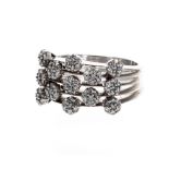 Modern 18ct white gold diamond dress ring, applied with thirteen floral set clusters on split