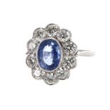 Impressive platinum sapphire and diamond oval cluster ring, the sapphire 1.35ct, in a surround of