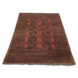 Persian orange ground rug, decorated with central panel of twelve medallion motif within multiple