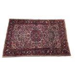 Antique handmade Persian Borchalo rug, with floral medallion on a densely foliate red ground, within