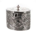 George III oval silver tea caddy, with hinged cover surmounted by an urn finial, floral embossed,