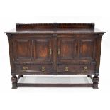 Jacobean style oak sideboard, with double fielded panelled cupboard doors over two drawers flanked