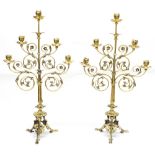 Pair of French decorative brass candelabra of ecclesiastical form, each with scrolling foliate