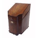 George III serpentine mahogany knife box, the locking cover enclosing pierced knife frame over later
