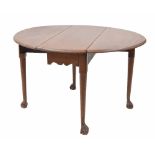 Georgian mahogany oval gateleg table with a shaped frieze upon cylindrical tapered legs