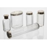 Set of five Victorian faceted glass and silver top dressing table jars, the engraved covers marked