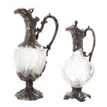 Two similar Art Nouveau style silvered pewter mounted glass claret jugs, each with wrythen fluted