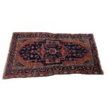 Antique Persian handmade Malayer rug, with red central medallion on a deep blue ground within