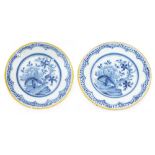 Pair of English Delft Ware blue and white plates, centrally decorated with branch and flowers within