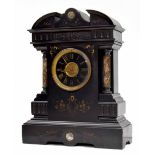Large French black slate and grey marble two train mantel clock striking on a gong, within a