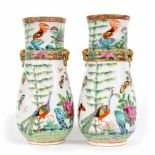 Pair of Chinese Canton famille rose porcelain cylindrical vases, each with moulded lions head ring