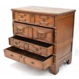 17th/18th century oak split moulded chest of drawers, with four panelled long drawers upon bracket