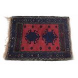 Persian red ground prayer mat, decorated with two stylized medallions within multiple flower head