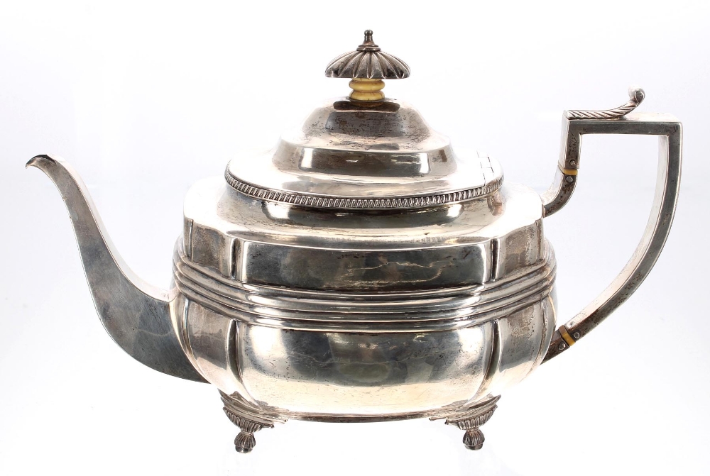 George III silver boat shaped teapot, with leaf capped handle and reeded body upon on shaped feet,