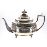 George III silver boat shaped teapot, with leaf capped handle and reeded body upon on shaped feet,