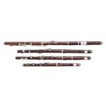 Three old rosewood and nickel mounted flutes, one stamped Hy. Potter & Co, London; also an old fife,