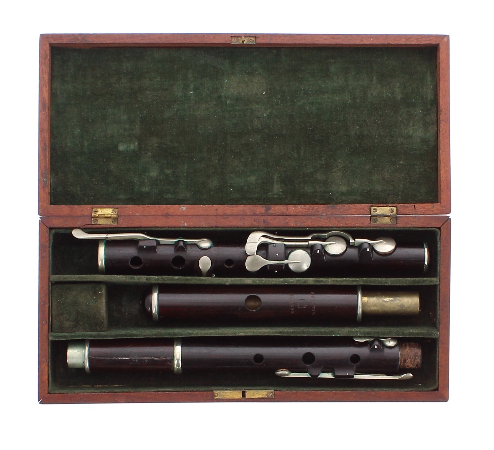 Old rosewood flute by and stamped Haynes, Kaloton, with eight nickel keys on wooden blocks, mahogany