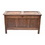 17th/18th century oak coffer, the hinged top over the triple panelled front with foliate scratch