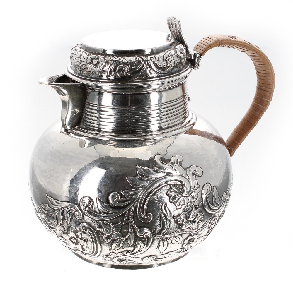 George III silver hot water pot, London 1809, with a half foliate embossed body and rattan bound