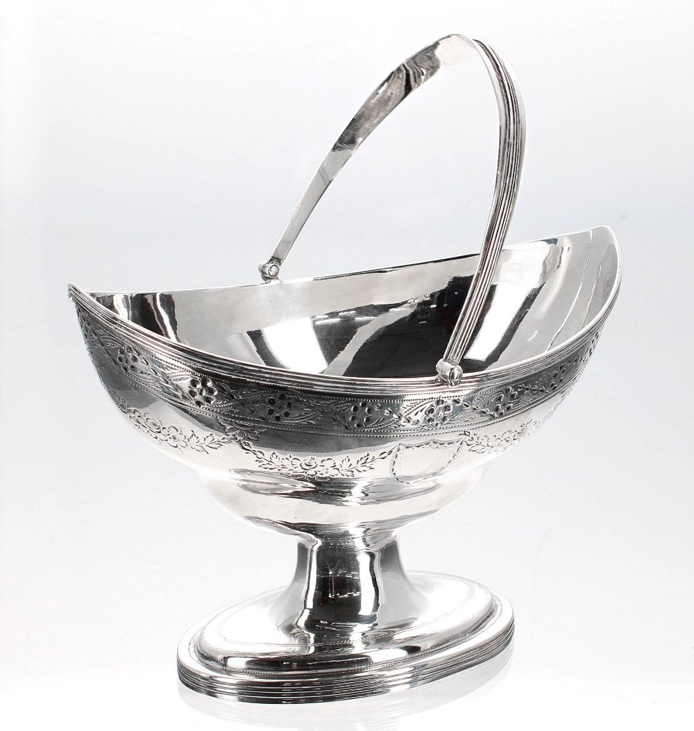 George III silver boat shaped sugar basket, with pricked and engraved borders and floral swag