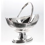 George III silver boat shaped sugar basket, with pricked and engraved borders and floral swag