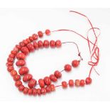 Two coral coloured stone bead necklaces (2)