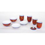 Japanese porcelain part tea set, decorated in gilt with flying cranes on a deep red ground,