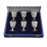 Cased set of six Sterling stirrup cups, decorated with a foliate embossed band, 2.5" high, 5.5oz t