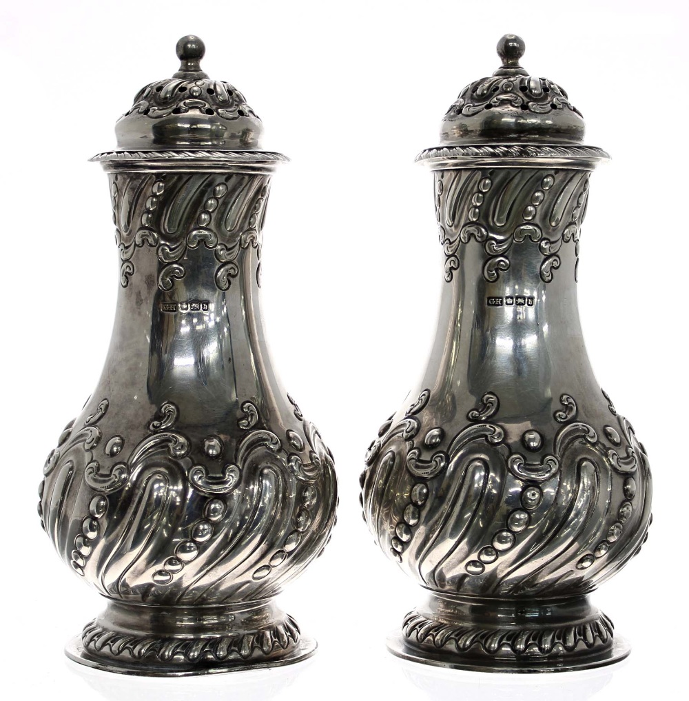 Good pair of late Victorian silver sugar casters, of wrythen fluted baluster form with scrolling