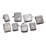 Collection of eight late Victorian and early Edwardian silver vesta cases, seven with scrolling
