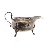 George II silver cream jug, with capped C-scroll handle raised on three scroll feet, maker Paul