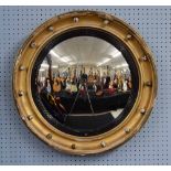 19th century giltwood circular convex wall mirror, the moulded frame with applied roundels with an