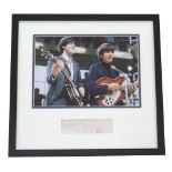 The Beatles interest - autograph cutting bearing two signatures in red ink, within a glazed framed