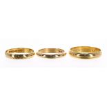 Two 22ct wedding band rings, 7.4gm; also an 18ct wedding band ring, 4.8gm, the largest 4.5mm wide (