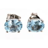 Pair of blue topaz oval ear studs in silver, 8mm x 6mm