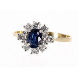 18ct sapphire and diamond cluster ring, the oval sapphire of a rich blue colour 0.90 ct approx, in a