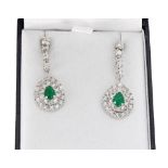 Fine pair of 18ct white gold pear drop emerald and diamond cluster earrings, the emeralds 1.39 ct