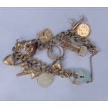 9ct yellow gold charm bracelet with a heart shaped padlock clasp, 29.3gm