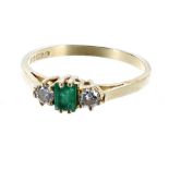 18ct yellow gold emerald and diamond three stone ring, the emerald 0.20ct flanked with round