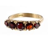18ct five stone claw set garnet ring, 3.0gm, width 5.5mm, ring size L/M