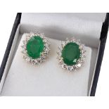 Good pair of 18ct emerald and diamond oval cluster stud earrings, the oval emeralds 5.79ct in total,