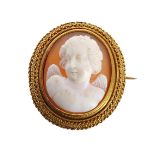 Antique oval shell cameo brooch, carved in high relief with a winged putti set within a high grade